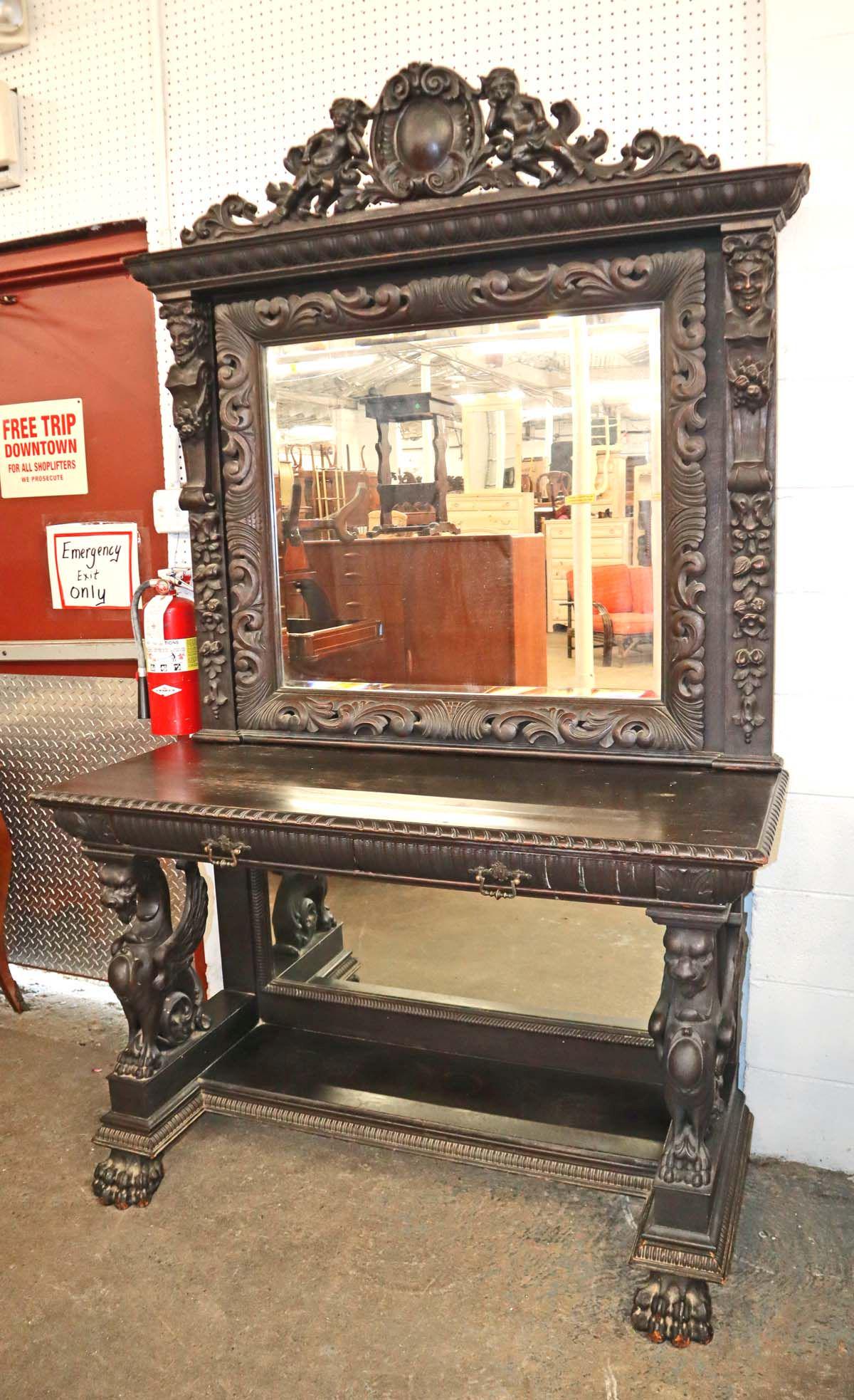 Awesome antique oak wing griffin console table with highly carved with cupids, RJ Horner: Awesome antique oak wing griffin console table with highly carved bevel glass mirror with cupids, in original finish, in good condition for age, attributed to RJ Horner approx. 54" w x 22" d x 86" h
