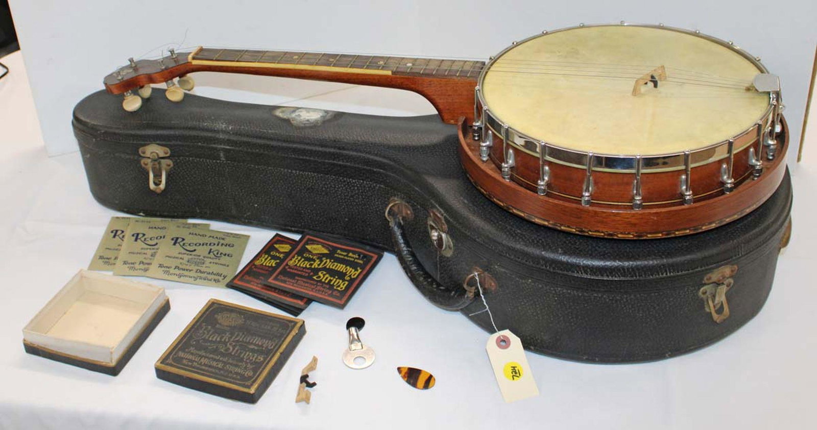 Semi antique banjo with rosewood and mahogany inly neck in original case: Semi antique banjo with rosewood and mahogany inly neck in original case, comes with picks, key and black diamond strings in box approx. 32" w x 15" d x 5" h