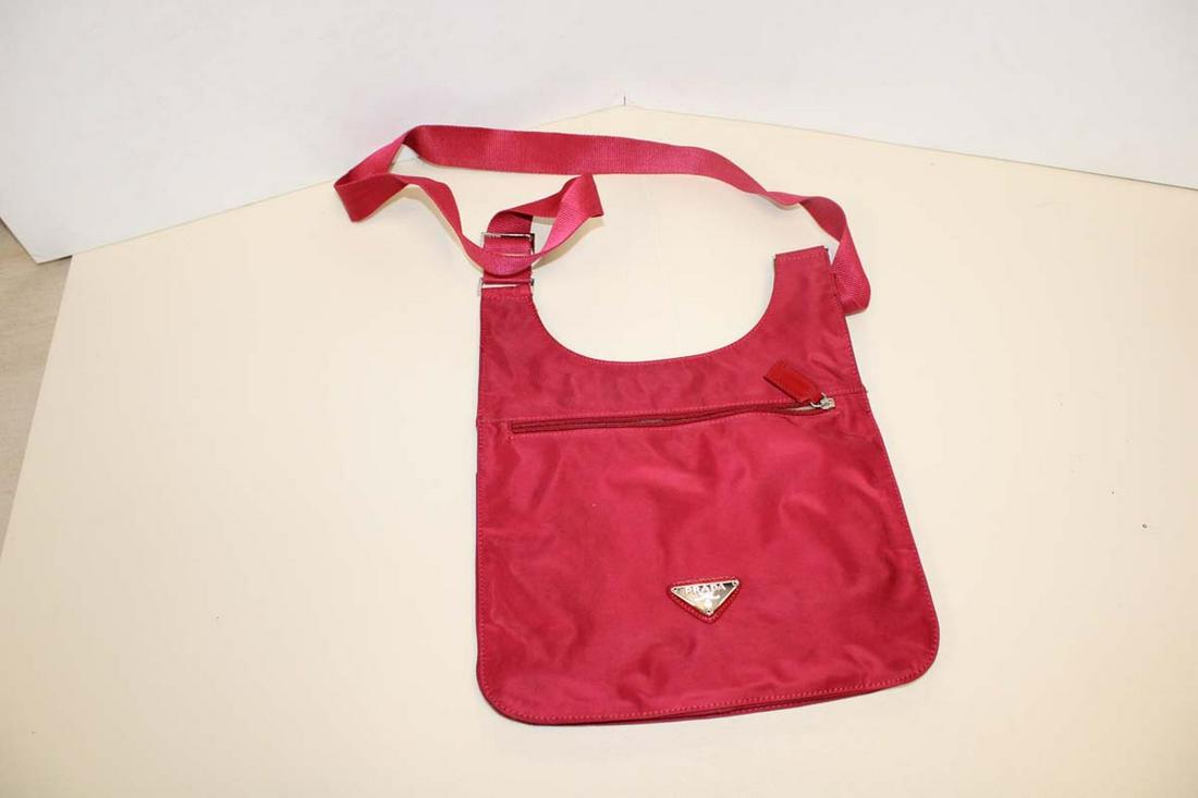 Red shouldered strapped purse marked Prada approx. 12" w x 2" d x 14" h NOT AUTHENTICATED: Red shouldered strapped purse marked Prada approx. 12" w x 2" d x 14" h NOT AUTHENTICATED (Bid at own judgement)