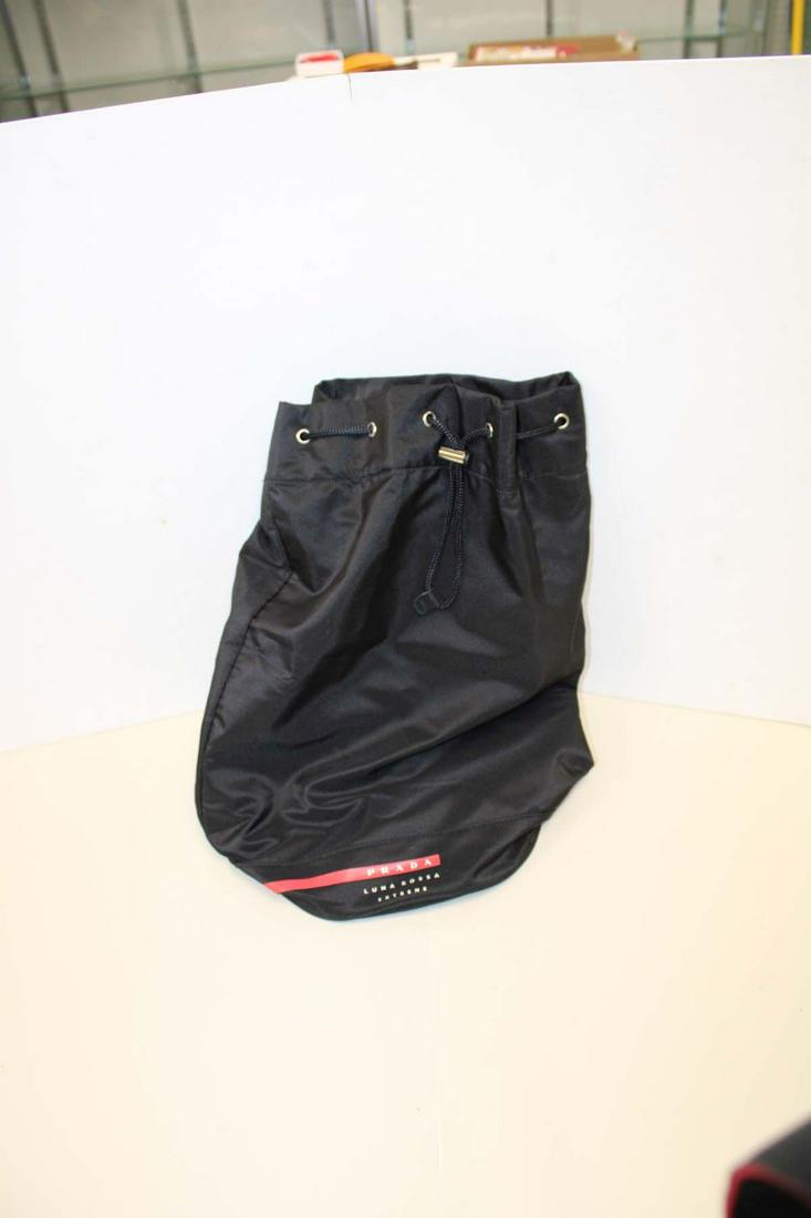 Prada style black duffle Black duffel bag style marked Prada approx. 10" diameter x 20" h: Black duffel bag style marked Prada approx. 10" diameter x 20" h NOT AUTHENTICATED (Bid at own judgement)