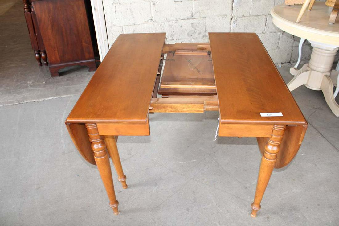 Drop side walnut dining room table: Drop side walnut dining room table with self storing 12" leaf approx. 28" w x 42" d x 30" h opens to 72" w