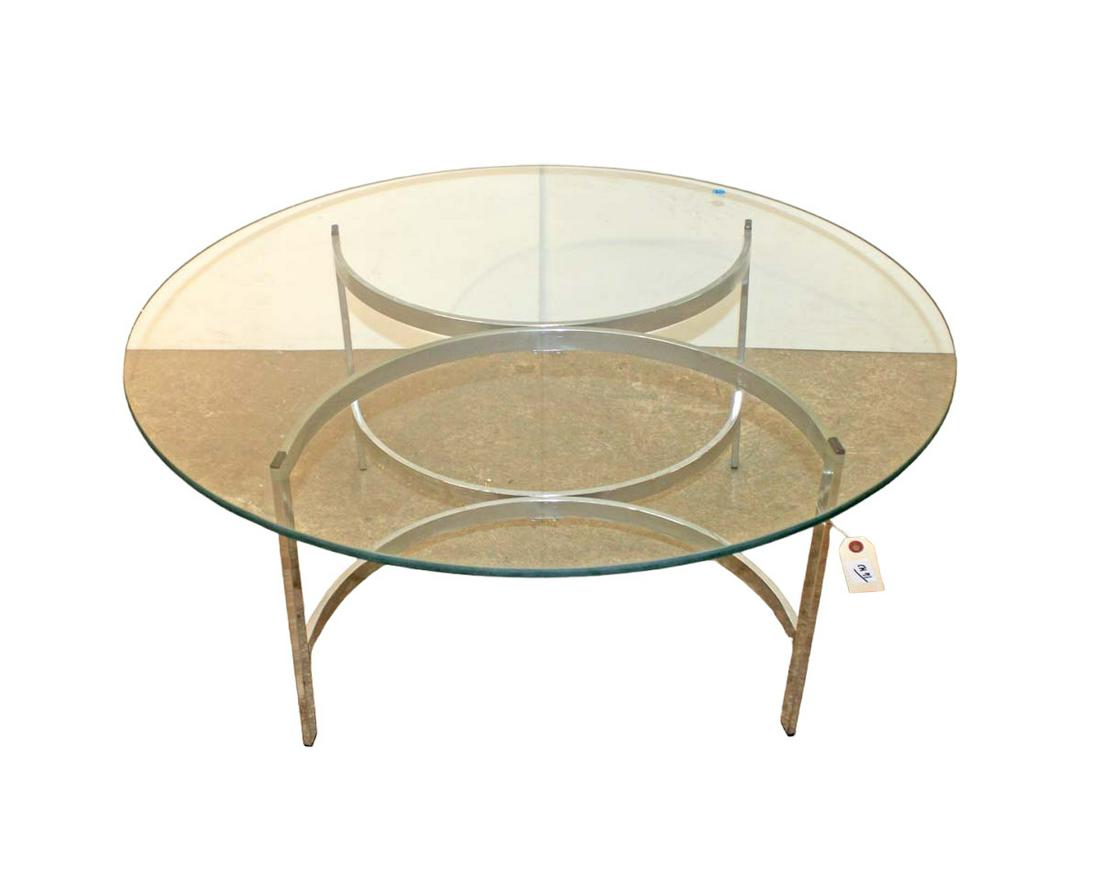 Chrome and glass top cocktail table in the manner of Milo Baughman: Chrome and glass top cocktail table in the manner of Milo Baughman approx. 36" diameter x 15" h