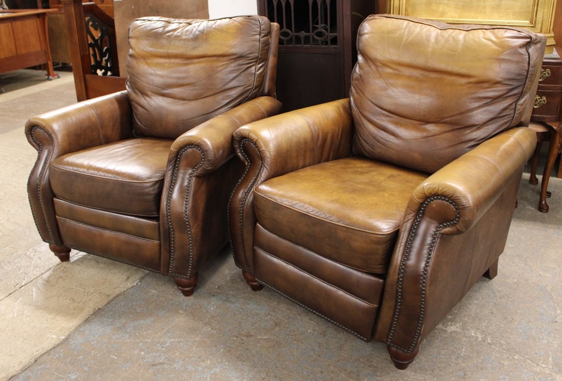 Pair Leather Recliners with Industrial style tacking: Pair of leather recliners with industrial style tacking on arms, no name found, but feels quality, does show patina, structurally sound, no rips or tears, working as should, in a dark butterscotch sty