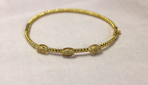 Diamond and 14kt yellow gold hinged bangle bracelet over sterling silver approx. 2 1/2" diameter