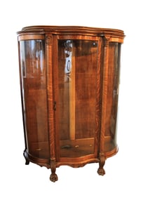 Antique oak serpentine china cabinet, heavily carved feet, original shelves