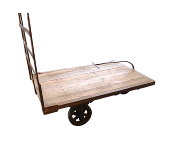 Industrial warehouse cart with pull handle in metal frame and wooden deck, cast iron and rubber