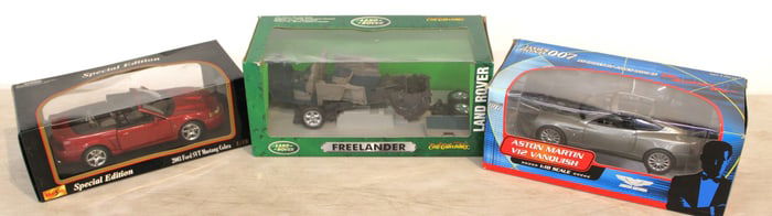 3 model cars: 2 diecast cars in boxes and 1 partial, Mustang, Aston Martin, Land Rover Freelander