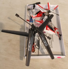 Assortment of helicopters and parts, remote controls RC working unknown