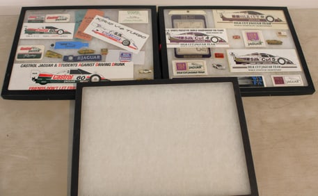 3 Display cases with race day tickets, car badges, stickers and other memorabilia (one case is