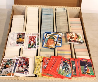 Large box of mixed football and baseball trading cards