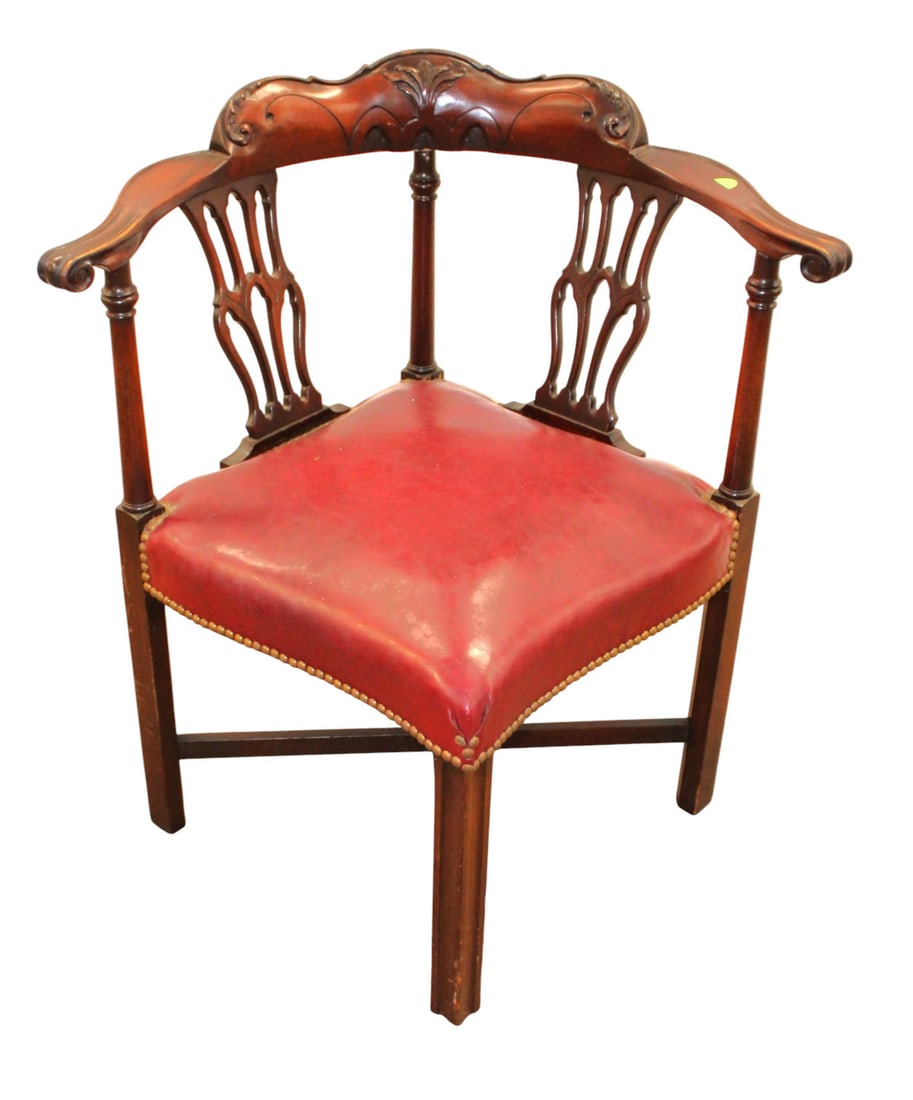 Antique carved and fancy mahogany corner chair with leather tacked seat: Antique carved and fancy mahogany corner chair with leather tacked seat, structurally sound and in original found condition and finish. 33"h x 30"w x 27"d seat height 18"