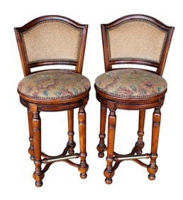 Pair Carlton Manor mahogany swivel bar stools with brass foot rests
