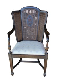 Antique wicker back carved medallion arm chair in a black finish