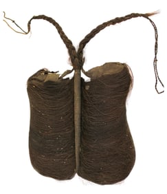 Indian hair artifact possibly shoes in display case. Case is 16x12