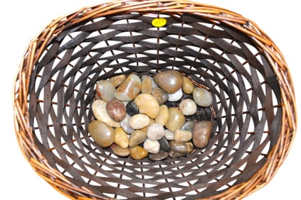 Woven basket with polished stones. Basket 9"h x 13"l x 10"w