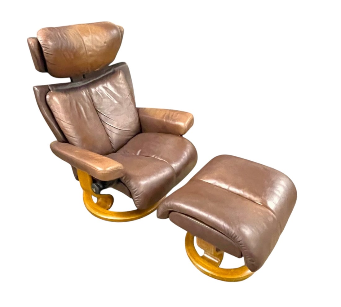 Ekornes stressless leather chair and ottoman: Ekornes 2 piece stressless leather chair and ottoman in the cigar brown with walnut base, good model with adjustable head rest, structurally sound and in good condition, leather does have patina, no r