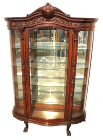 Antique R.J. Horner heavily carved oak serpentine with paw feet china cabinet