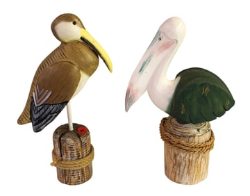 2 wooden pelicans on post. 12"h x 8"l x 4"d