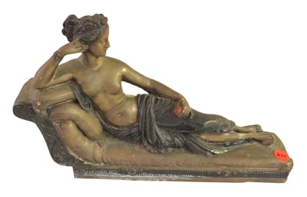 Antique bronze finish figure of a woman on chaise lounge