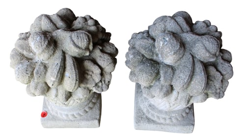 Pair of cast stone decorative flowers in basket