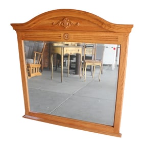 Oak framed and beveled glass carved mirror
