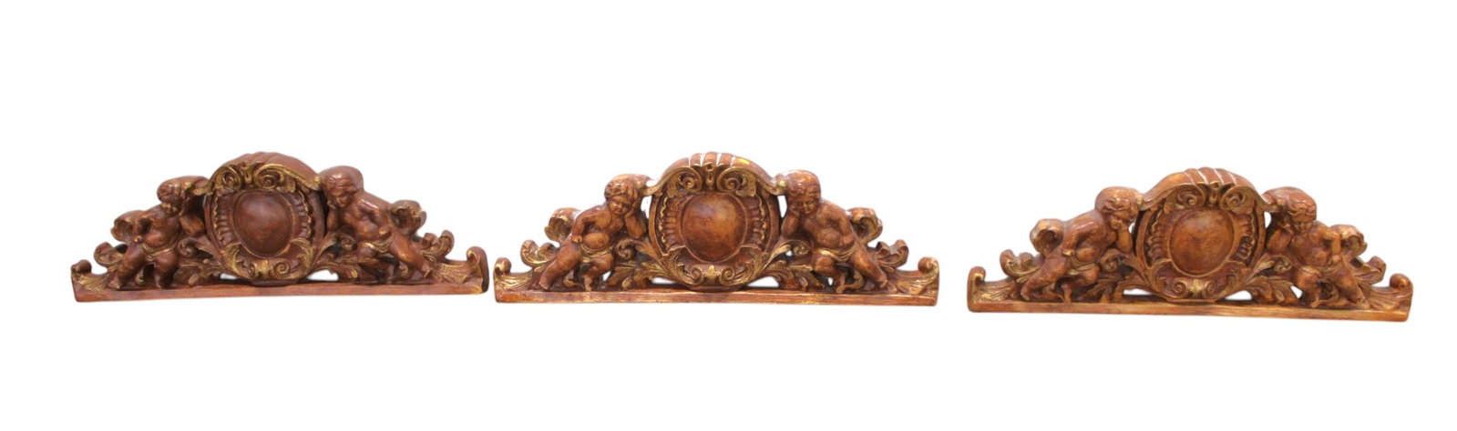 3 cherub carved crests: 3 cherub carved crests, unknown heavy composition, structurally sound and in good condition. 11"h x 31"l x 3"d
