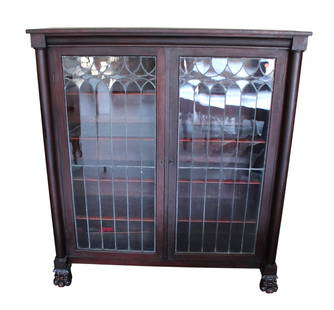 Antique mahogany lead glass paw foot bookcase: Antique mahogany lead glass 2 door bookcase with paw feet, 8 adjustable wood shelves, lead glass is good, with key, original finish, structurally sound and in good condition for age. 54.5"h x 50"w x 1