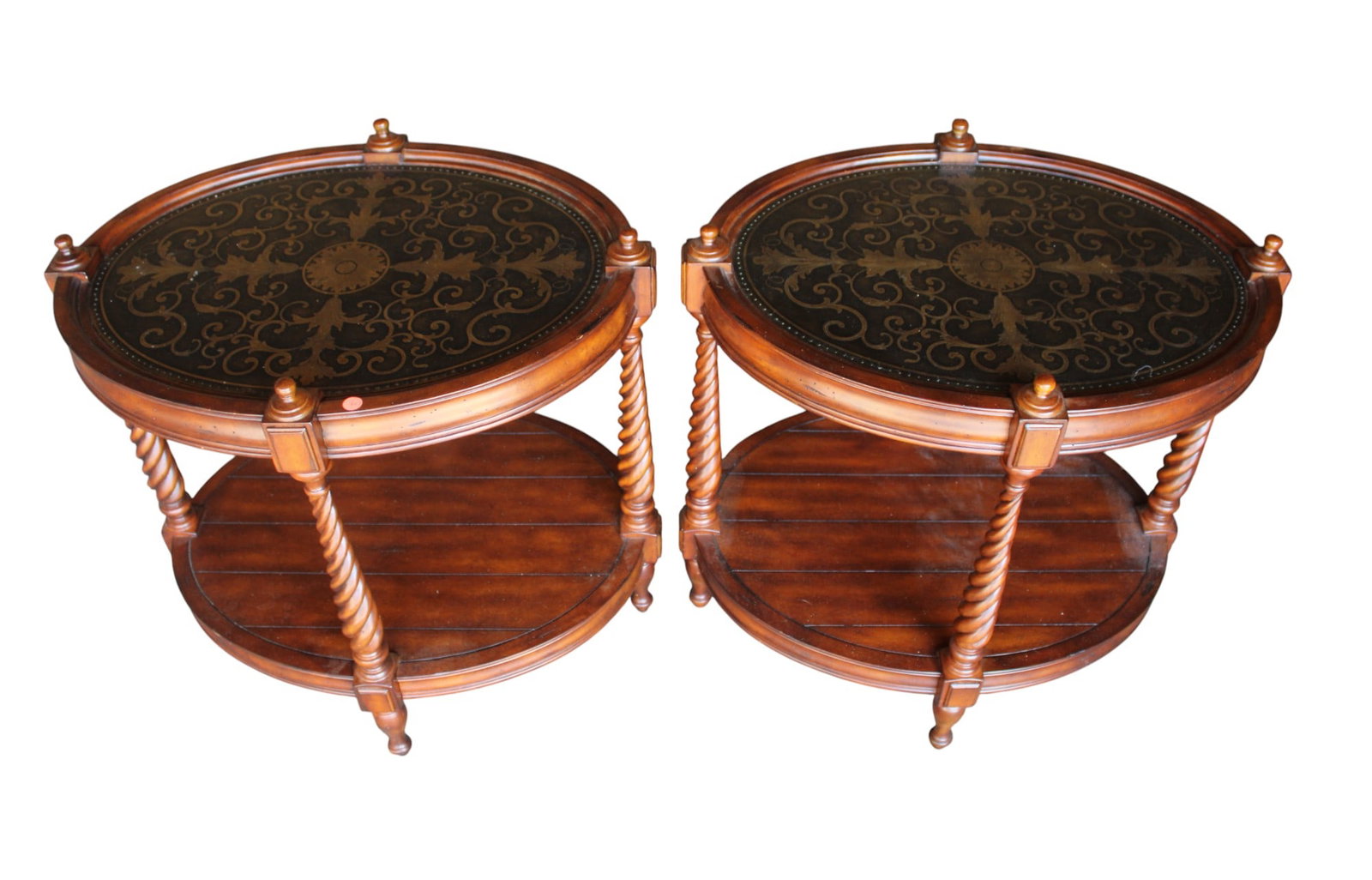 Pair oval lamp tables in distressed cherry finish: Nice pair of oval lamp tables in a distressed cherry finish with metal decorated top, original finish, structurally sound and in good condition. 26.5"h x 27.5"w x 22"d