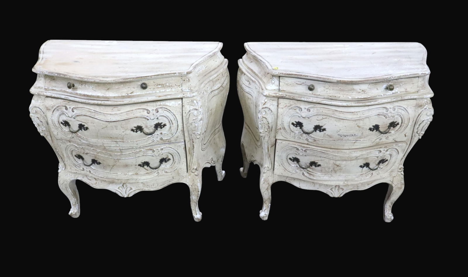 Pair of Italian paint decorated bombay nightstands: Pair of Italian 3 drawer paint decorated bombay nightstands in distressed off white finish, structurally sound and have a good look. Each 28"h x 33"w x 18.5"d