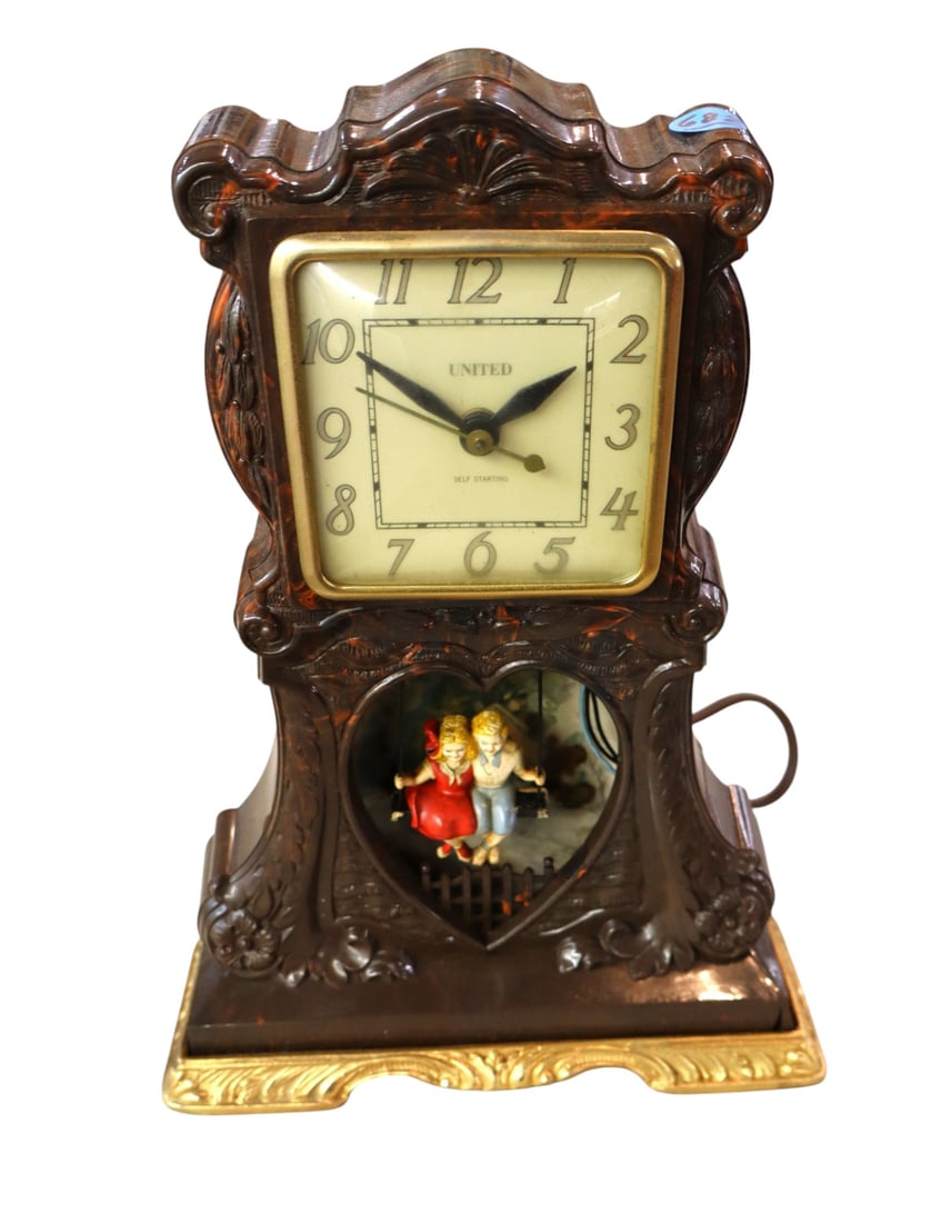 Vtg United Self Starting Bakelite electric clock: Vintage United Self Starting Bakelite electric clock with children on bench swinging. 12"h x 9"w x 3.25"d