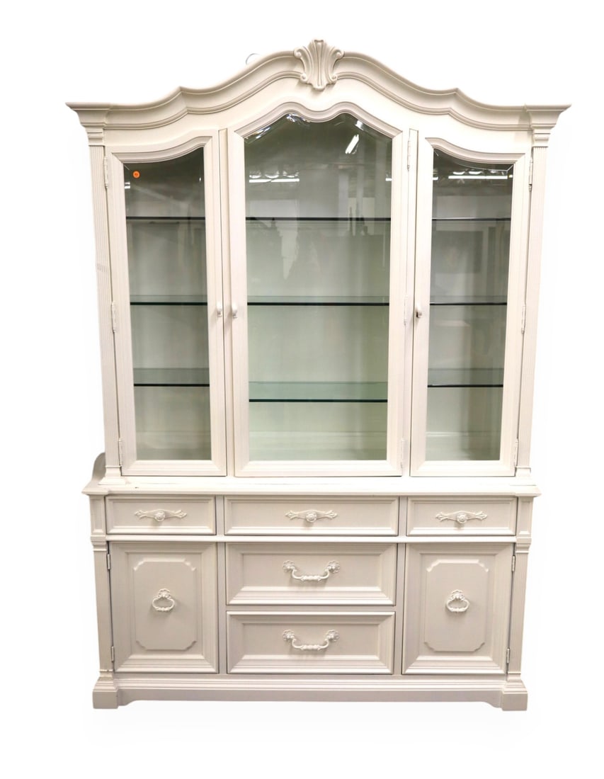 Vtg. White Furn country French white china cabinet: Vintage country French china cabinet in the professional white painted finish by White Furniture Company, 3 beveled glass doors with 9 adjustable glass shelves, 2 doors and five drawers in base. Match