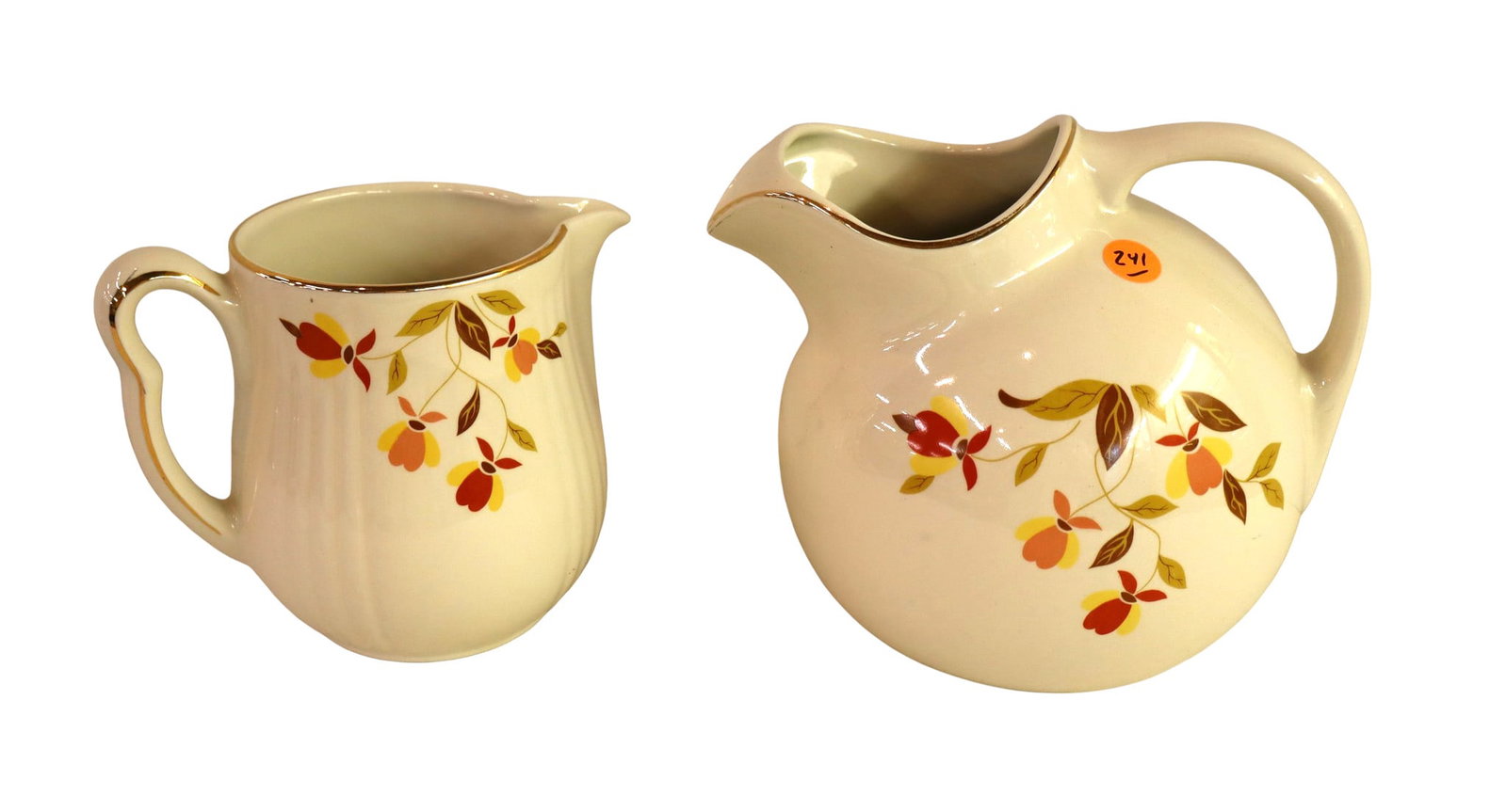 2 Hall Jewel T Autumn leaf pattern water pitchers: 2 Hall Jewel T Autumn leaf pattern single handled water pitchers, no noticeable issues. 7.5"h x 9"l x 6.5" diameter with handle, 6"h x 7"l with handle and 5" diameter