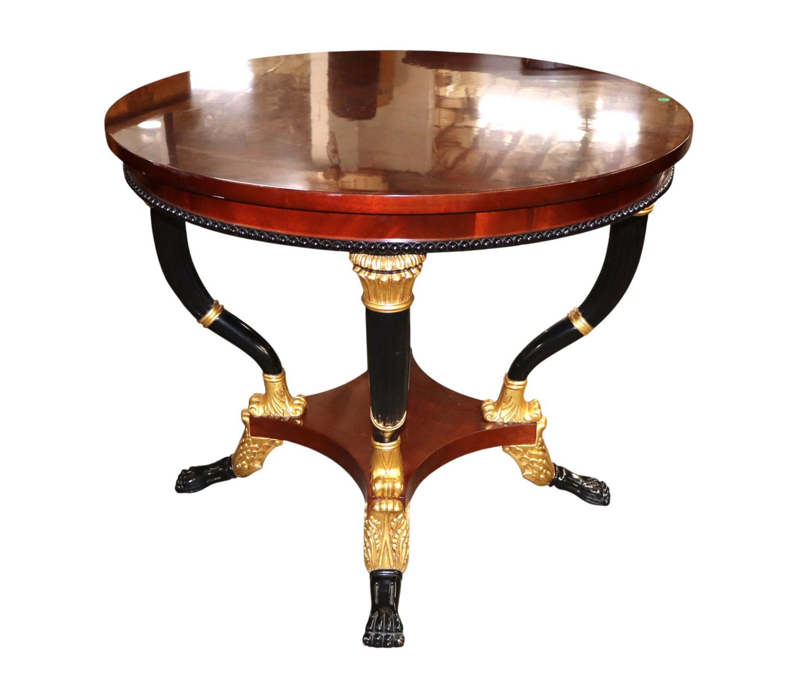 Astoria Grand Gigasso 35" book match center table: Astoria Grand Gigasso 35" round center table in book match burl mahogany top with black and gold legs with paw feet, original finish, structurally sound and in good condition with slight wear on top. 