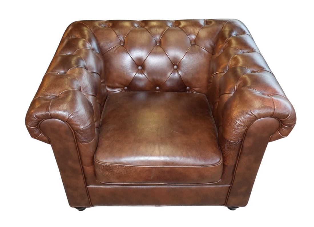Brown leather even arm button tuft club chair: Brown leather even arm button tuft club chair, structurally sound with some wear on arms. 30"h x 42"w x 35"d seat height 19"