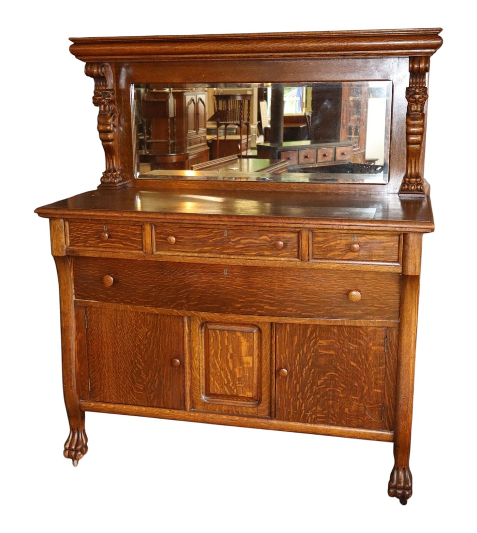 Antq Oak Lion Head Bevel Mirror Paw Foot Buffet Orig: Antique oak lion head bevel mirror back buffet with paw feet, original finish, structurally sound and in good condition for age, mirror is removeable for transit. Buffet 64.5"h x 54"w x 24.5"d. Mirror