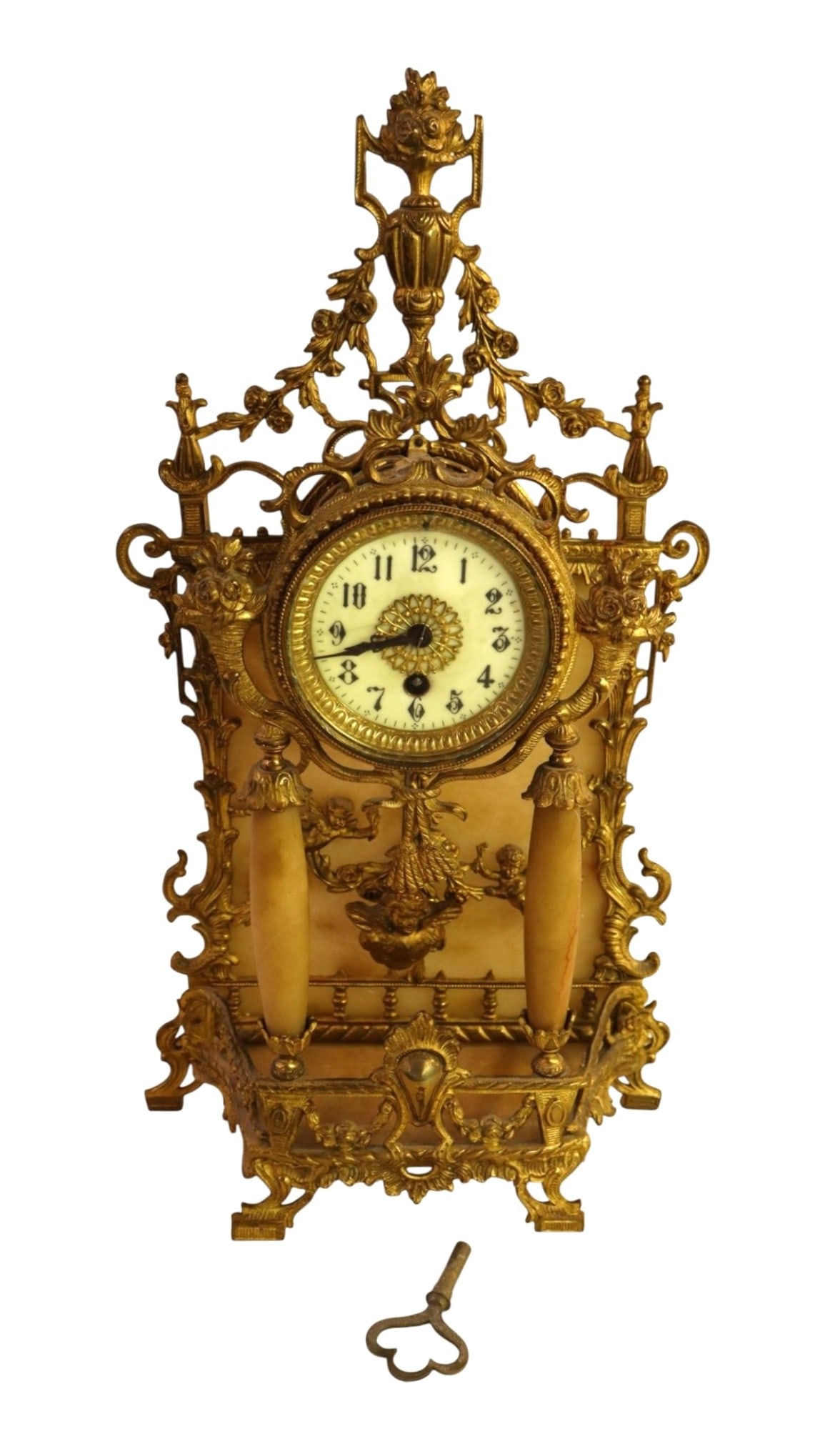 Antique French Gilt Bronze Alabaster Mantel Clock: Fine 19th-century French Rococo Revival ormolu brass and alabaster mantel clock featuring an ornate openwork frame, flaming urn finial, and hand-painted porcelain dial. This 19" H x 10.5" W x 4" D