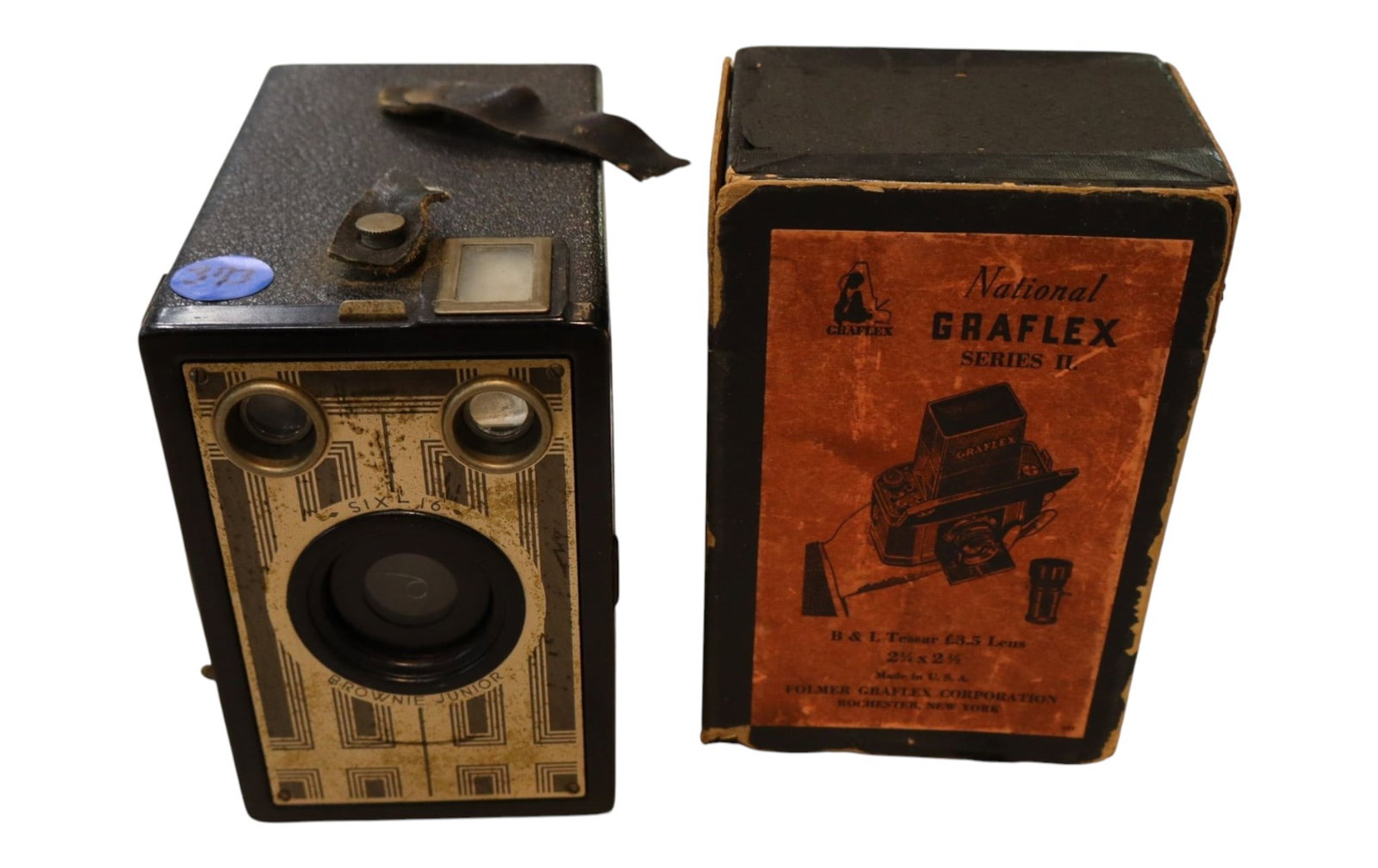 Antique Kodak Brownie Camera National Graflex Box: Vintage 1930s Kodak Six-16 Brownie Junior and rare National Graflex Series II SLR camera on original orange box. Displays exposure calculations, folding waist hood, and winding dials.