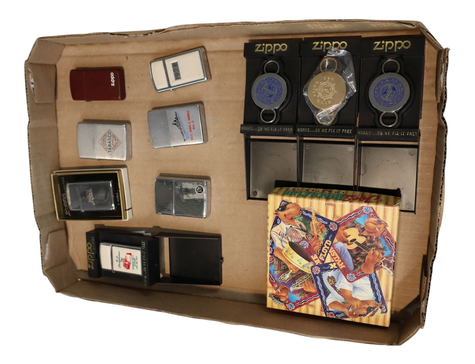 Vintage Beer Can Lighter Collection Tobaccoriana: Vintage Zippo tobacco advertising promotional lot. Features three plastic-mounted metal emblem pocket keychains in original plastic counter display stands. Includes a retro 1993 Joe?s Beach Club cork 