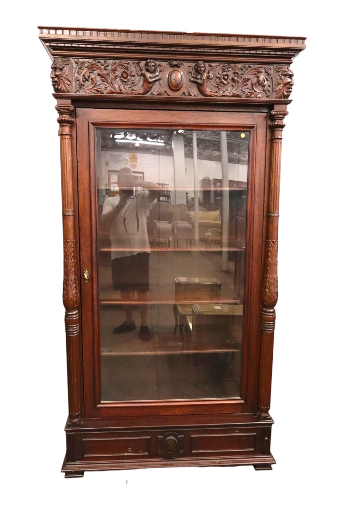 Antique Crvd Cherub Northwind Mahogany Display Case: Antique highly carved with cherubs and northwind faces mahogany 1 door display case with 4 adjustable wood shelves, may have been refinished over years, structurally sound and in good condition for ag