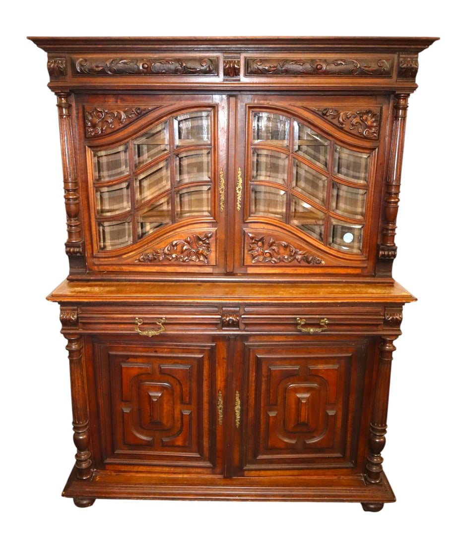 Antique 2-Pt Continental Mahogany Carved Cupboard: Antique 2 part continental mahogany carved cupboard with individual pane glass doors, original finish, structurally sound and in good condition for age. Footprint: 73.5" x 55"w x 22.5"d (top 35.25")