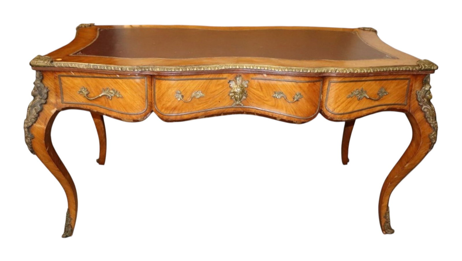 Satinwood French Leather Desk Bronze Lady Trim: Semi antique early import leather top French style desk in the satinwood with heavily applied bronze ladies and trim, original finish, structurally sound with veneer loss, nice piece for restoration. 