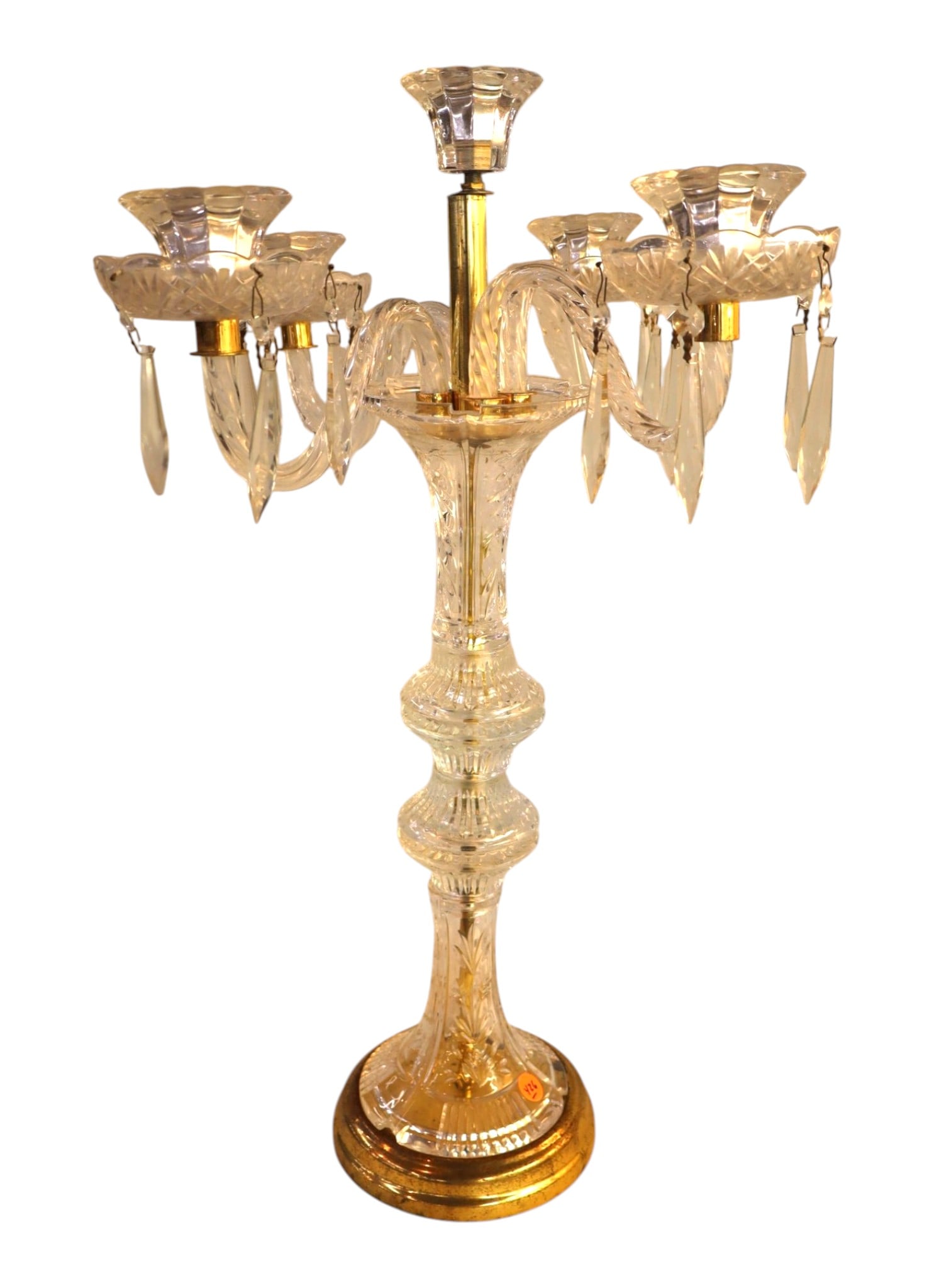 Vintage Lead Crystal 6 Light Candelabra Brass Base: Vintage Hollywood Regency 6-light lead crystal candelabra table centerpiece. Features a faceted cut baluster stem, five scrolled arms, brass base, and hanging lancehead crystal prisms, structurally so