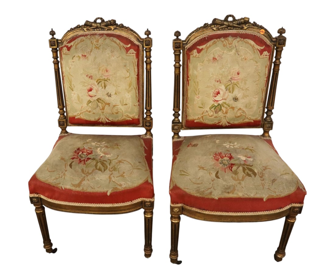 Pair of antique French side chairs: Pair of antique French side chairs with original needlepoint upholstery in carved gold gilt, structurally sound with wear on upholstery. Ea. 36.5"h x 20"w x 19"d seat height 19"