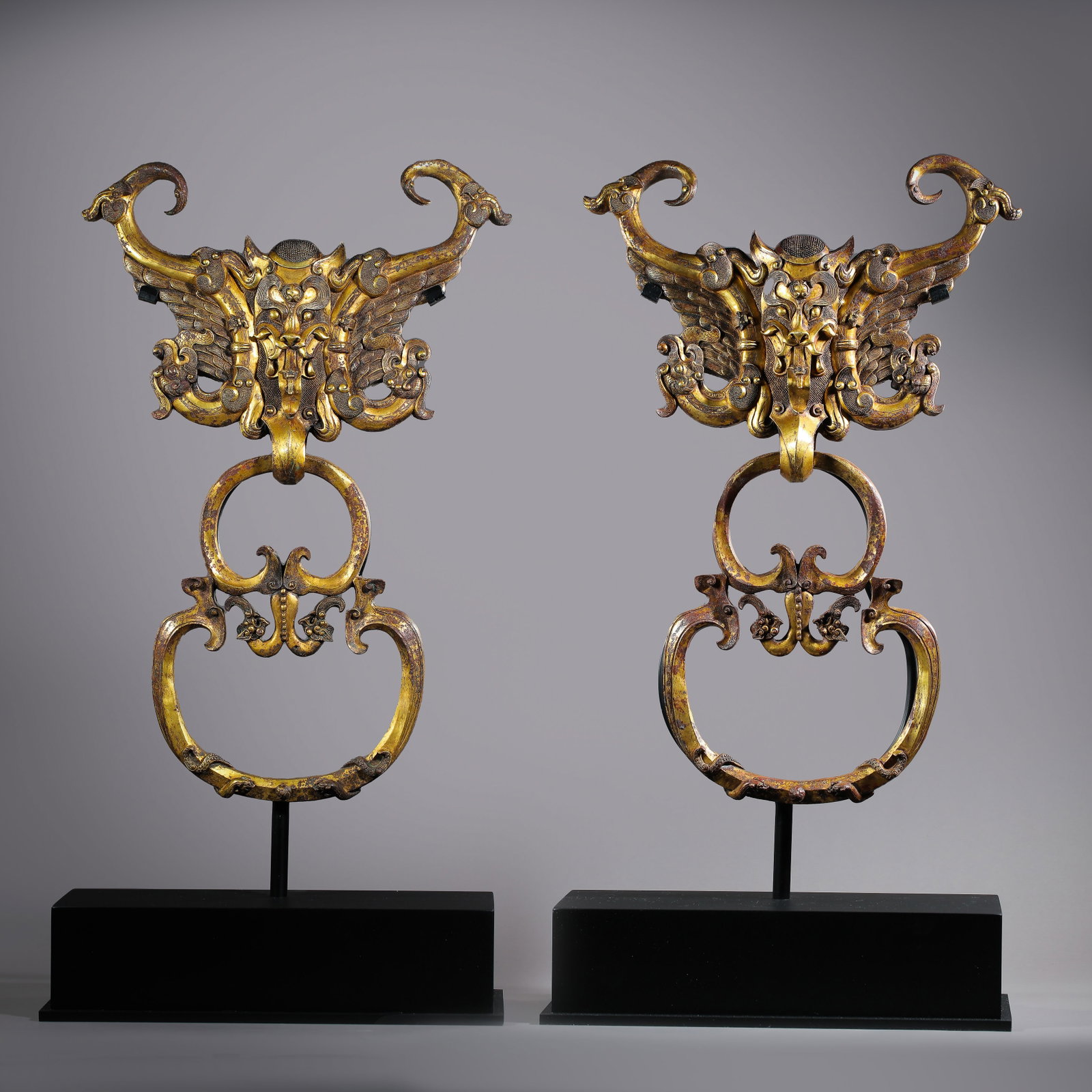 Pair of Chinese Han Dynasty gilt bronze shop Headles: H. 52 cm. W. 35 cm. Weight 9200 gram.