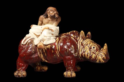 Arhats riding rhinoceros ornaments from Shiwan ware, Qing Dynasty, China