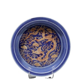 A Chinese Ming Dynasty Longqing period blue-glazed plate with dragon pattern and folded rim