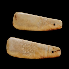 A pair of Chinese Neolithic jade objects with animal-face patterns