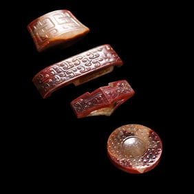 A set of Chinese Warring States period red agate sword ornaments