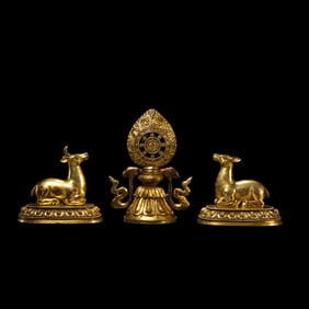 A group of Chinese Qing Dynasty gilt bronze Dharma wheel and twin deer