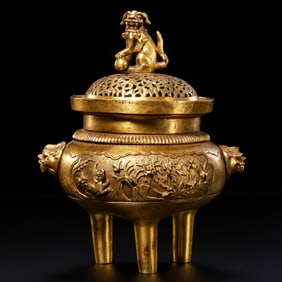 A Chinese Ming Dynasty gilt bronze tripod covered censer